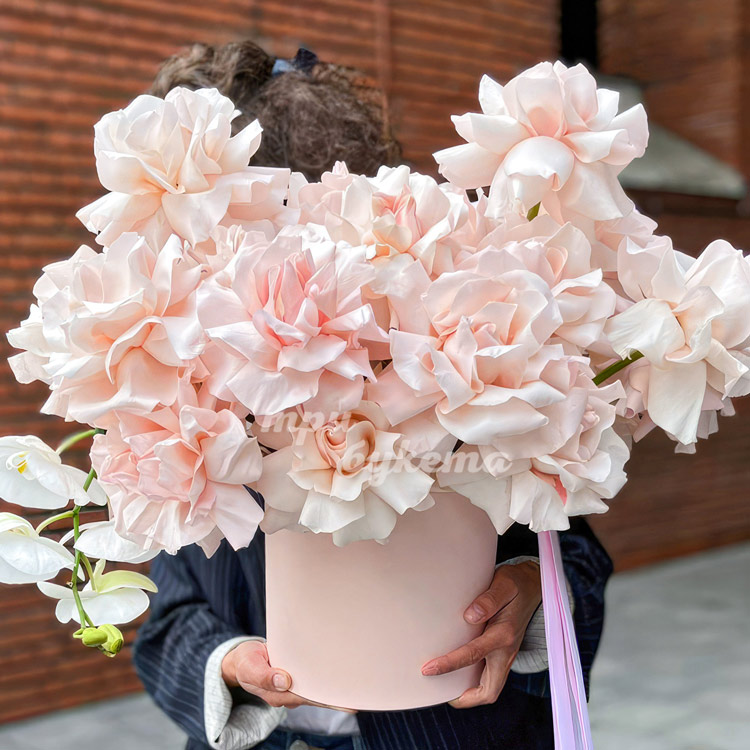 Шляпная коробка кремовых роз с орхидеями (крупный план)